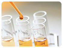 Oil dropper dispensing lubricant into test tube in Gulf Way’s modern production lab