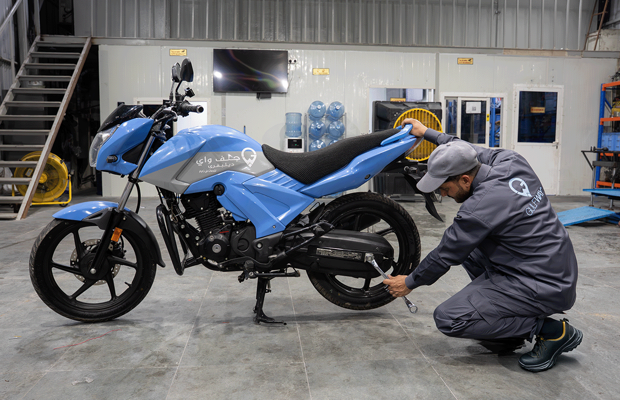 Gulf Way Oil Trading technician performing meticulous maintenance on a motorcycle in our fully equipped in-house garage for product integrity