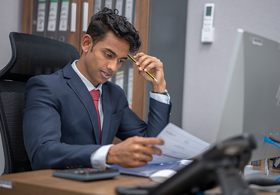 Gulf Way Oil Trading Accounts and Finance team member meticulously analyzing financial reports for strategic decision-making
